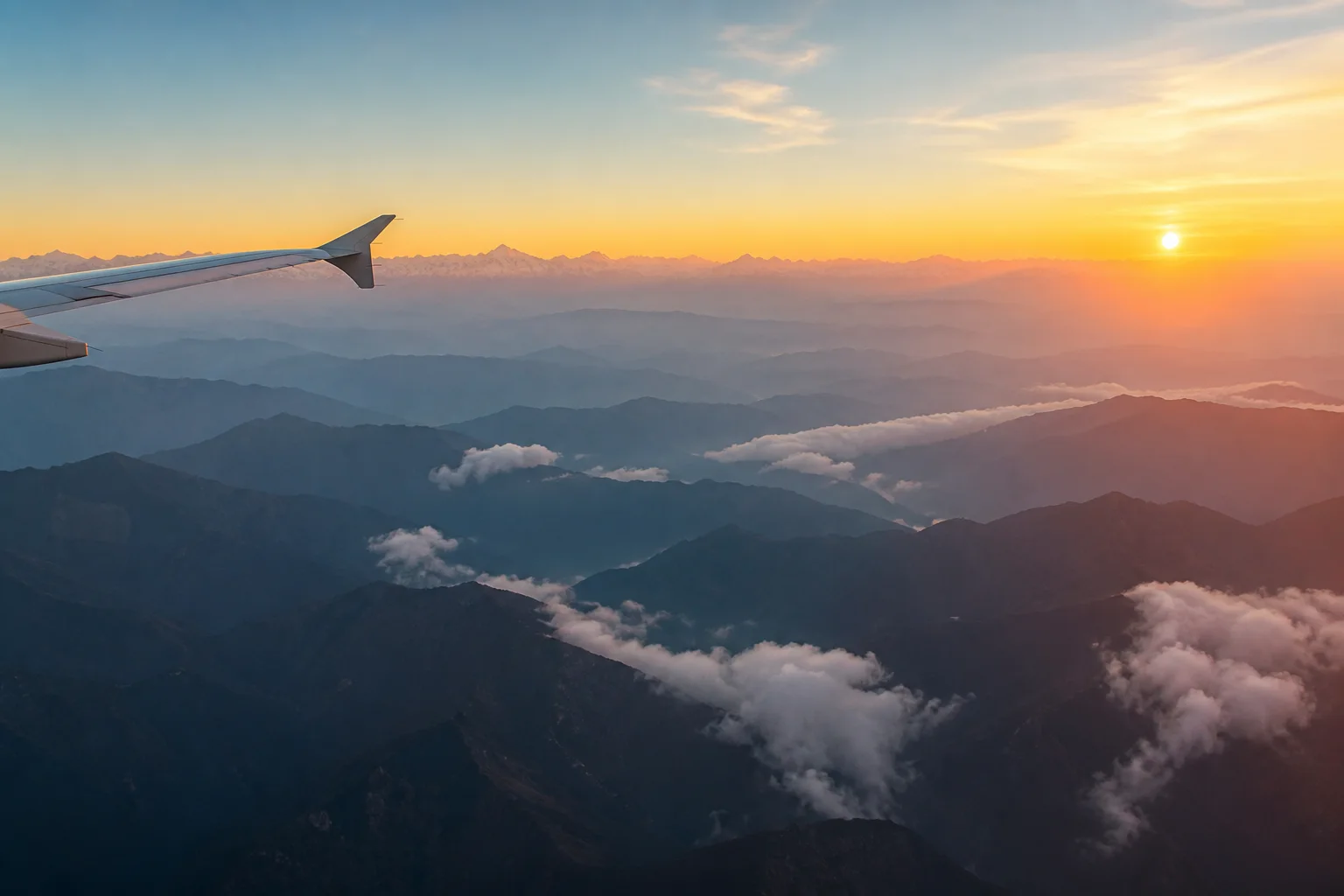 A sunrise flight above layered Himalayan foothills