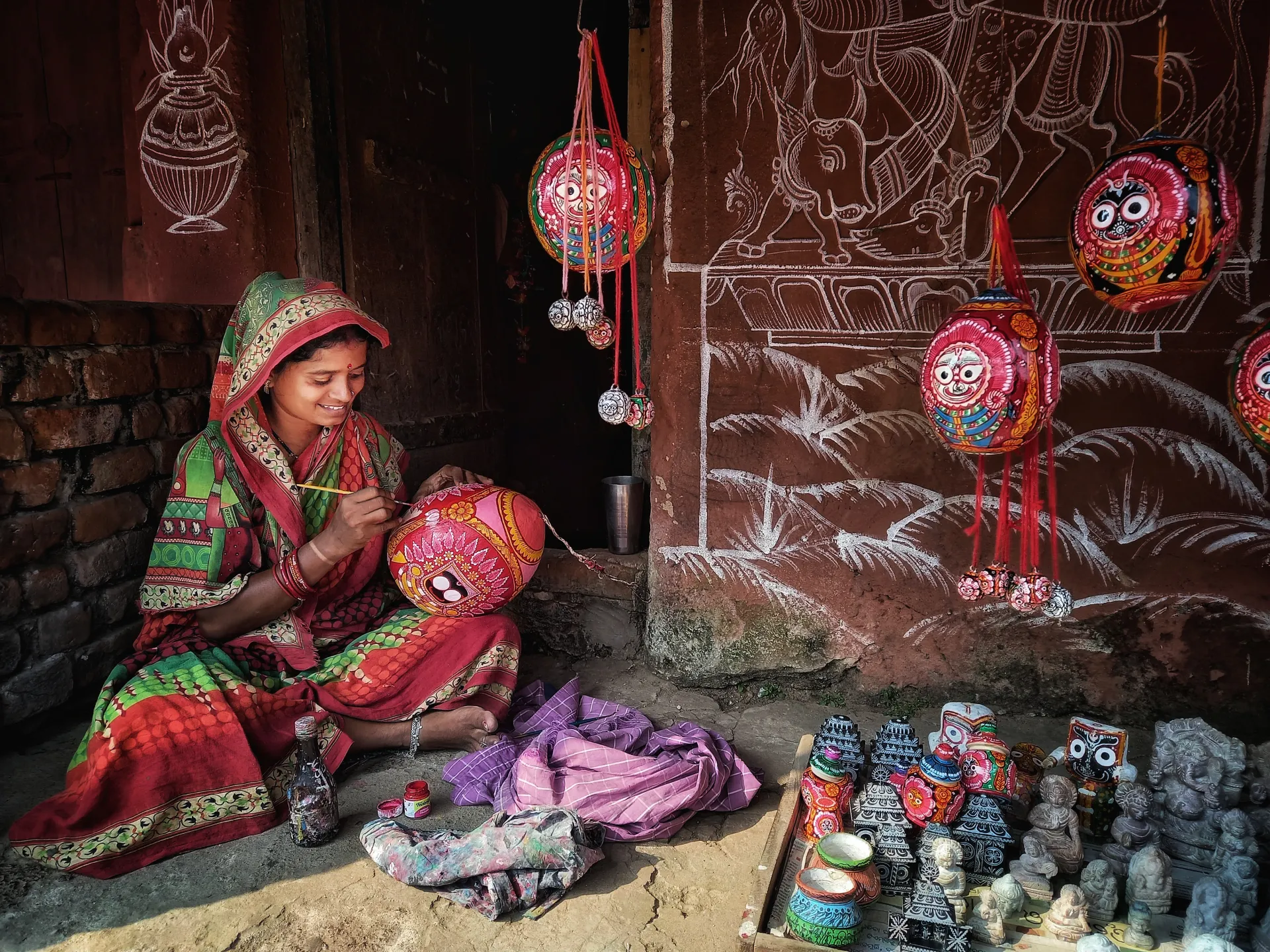 A Pattachitra artist painting a traditional artwork in Odisha