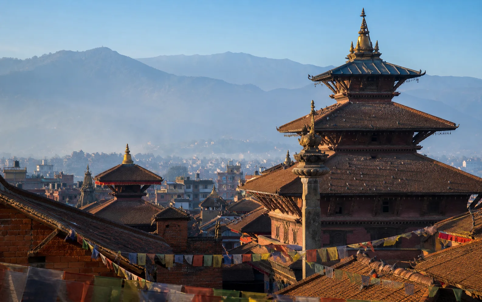 Historic temple roofs across the Kathmandu Valley in morning light